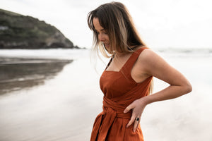 Freedom wearing linen Rossi Wrap on a New Zealand beach